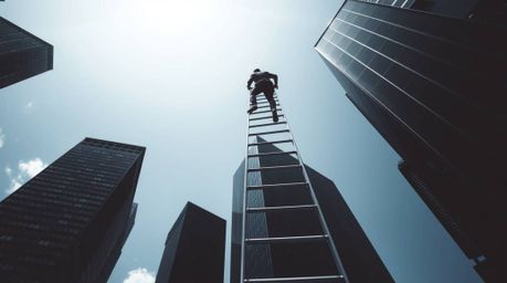 This series features classic black and white fine art photographs depicting a businessperson climbing a transparent ladder th