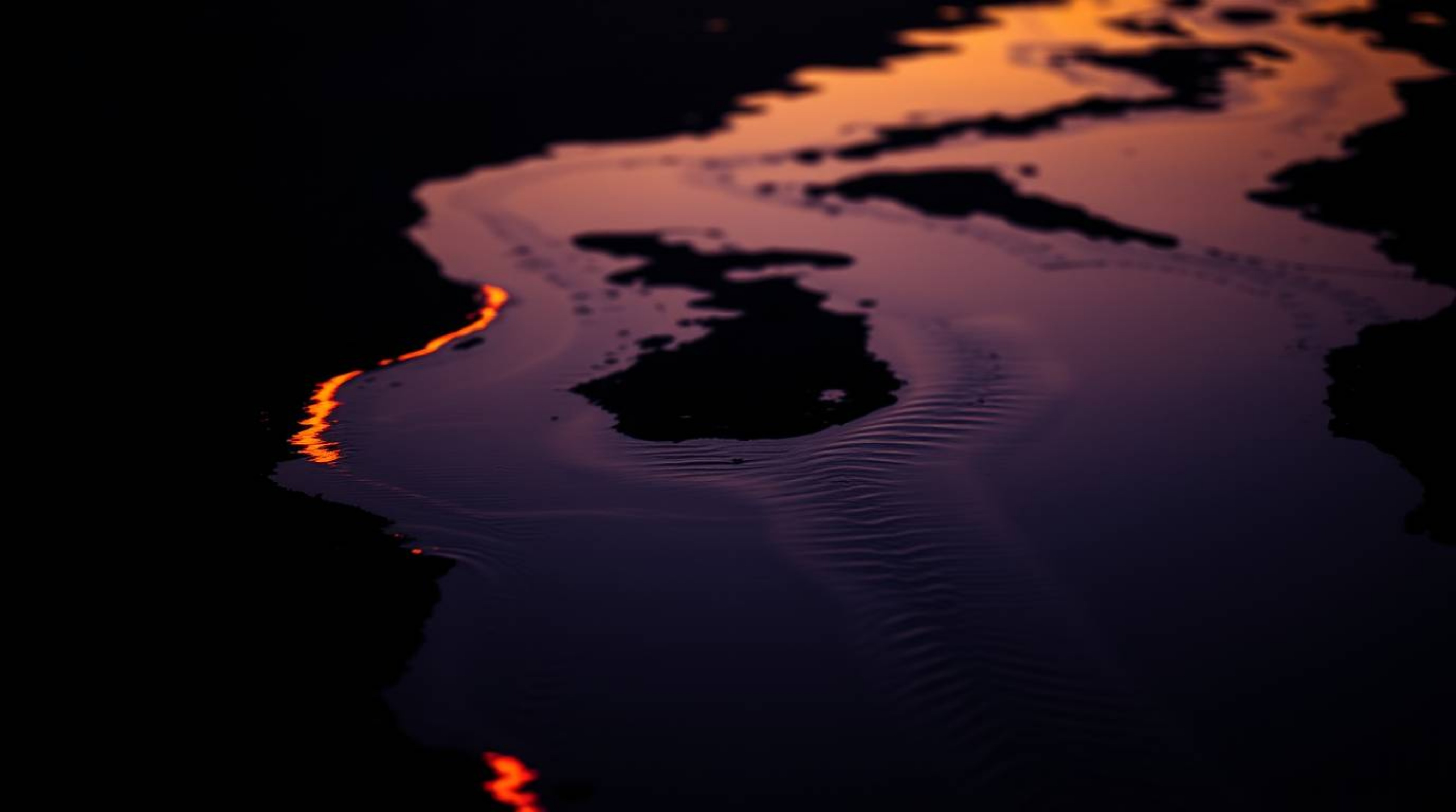 Experience the mesmerizing beauty of a river delta illuminated in the soft glow of twilight.  This image captures a tight clo