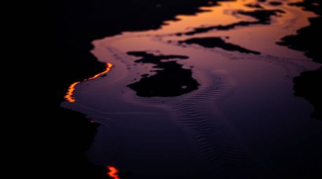 Experience the mesmerizing beauty of a river delta illuminated in the soft glow of twilight.  This image captures a tight clo