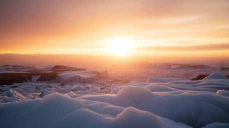 Experience the ethereal beauty of a sunset over icy polar glaciers. This stunning image captures the natural earth tones, bro