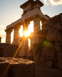 A warm golden glow creates a radiant and luxurious atmosphere in this tight close-up of ancient stone ruins. The image captur