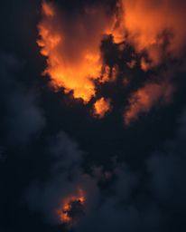 This stunning image captures an overhead, bird's-eye view of fiery cloud reflections in a serene mountain lake. Utilizing a t