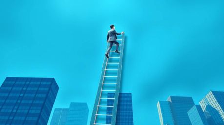 An intricate origami-style artwork depicts a businessperson ascending a transparent ladder into a vibrant blue sky above towe