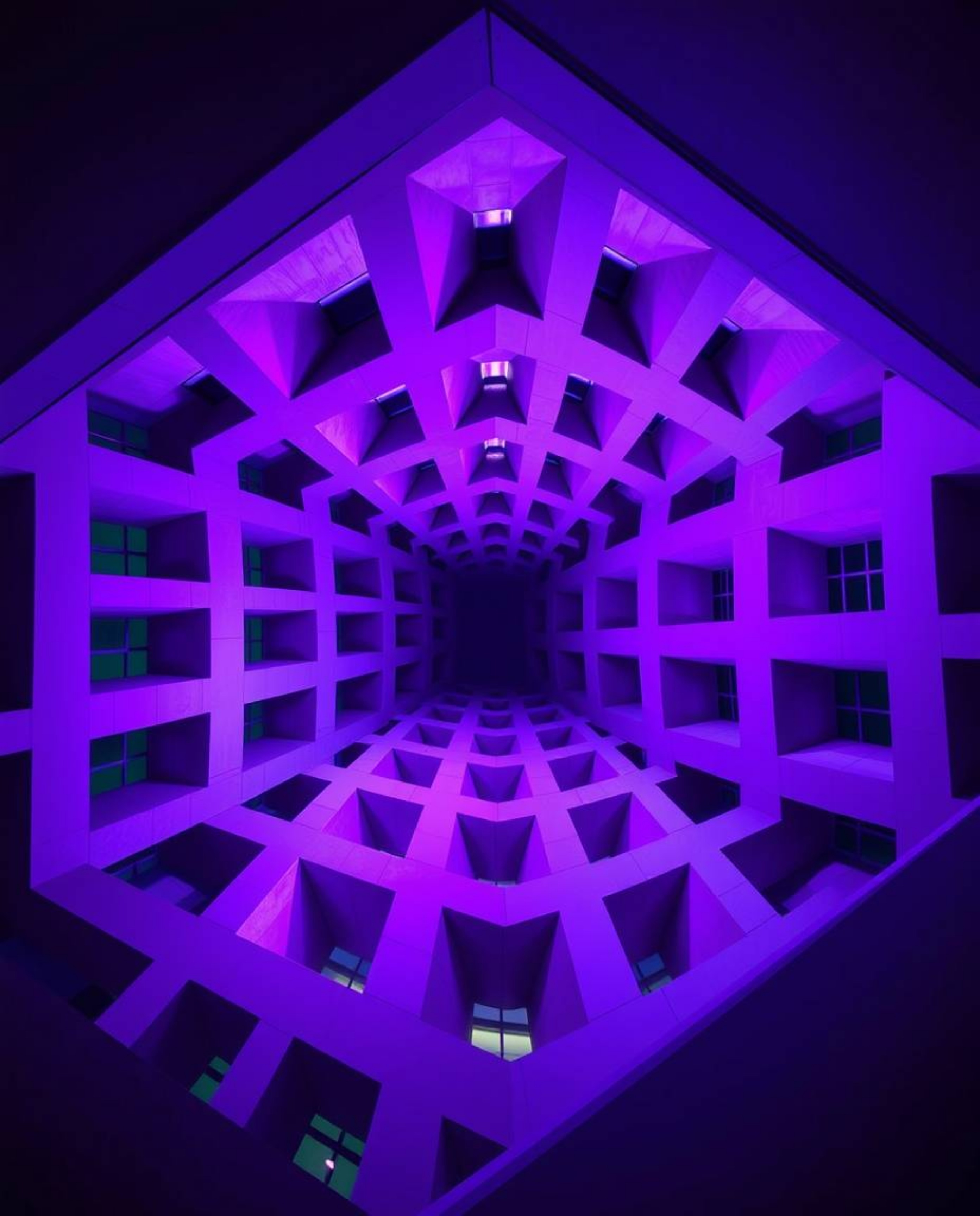 This architectural photograph showcases a mesmerizing repetitive cube pattern reminiscent of Escher's impossible geometries. 