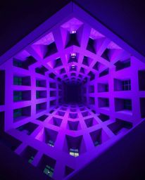 This architectural photograph showcases a mesmerizing repetitive cube pattern reminiscent of Escher's impossible geometries. 