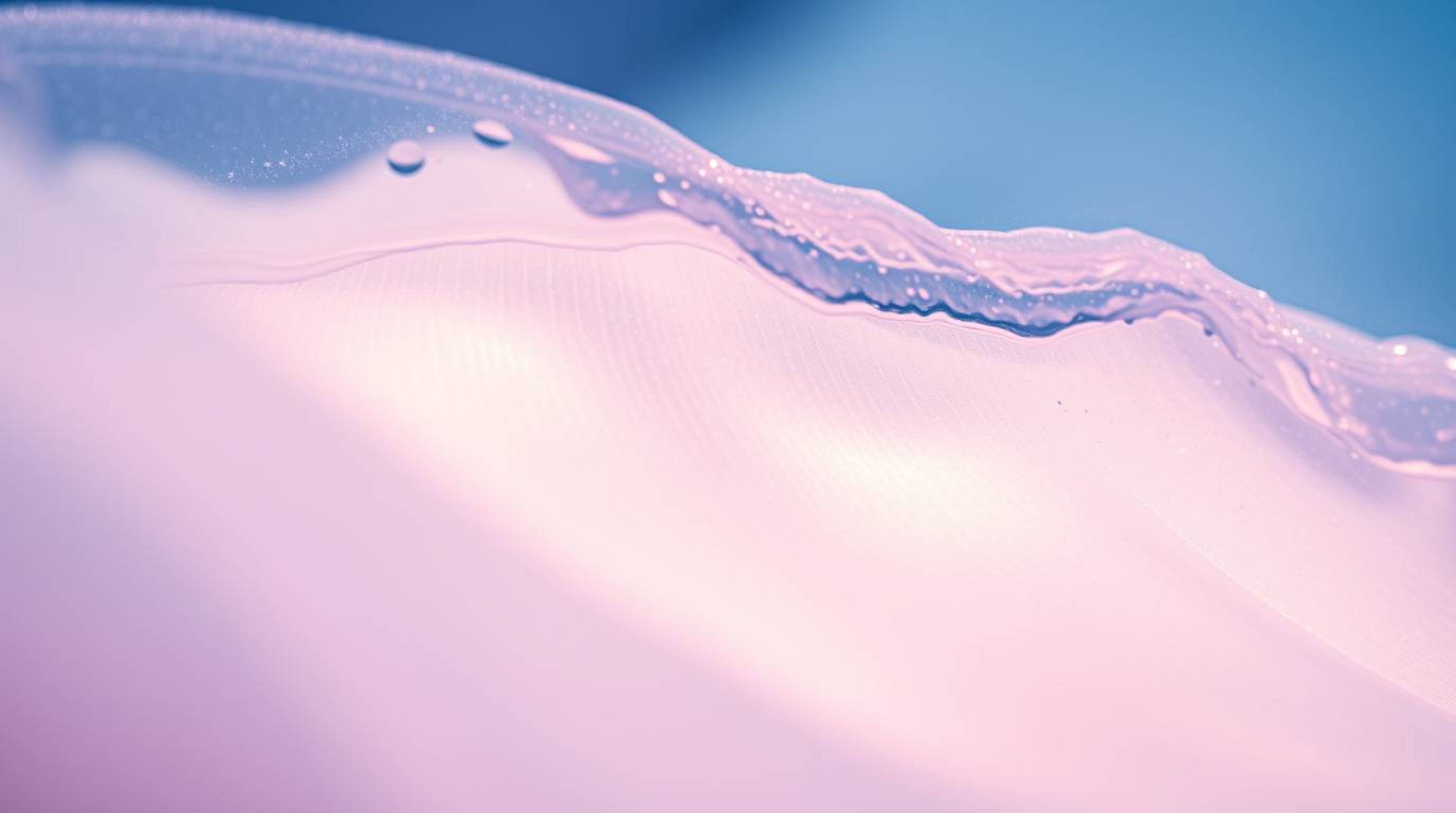 Experience the captivating beauty of a fluid abstract wave rendered in a soft pastel spectrum. This close-up shot showcases i