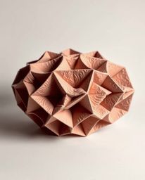 Explore stunning sculptural clay art rendered in monochrome, featuring a mesmerizing 3D geometric pattern reminiscent of fold