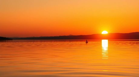 Experience the beauty of a vivid sunset reflected in a serene lake through modern flat design. This collection features extre