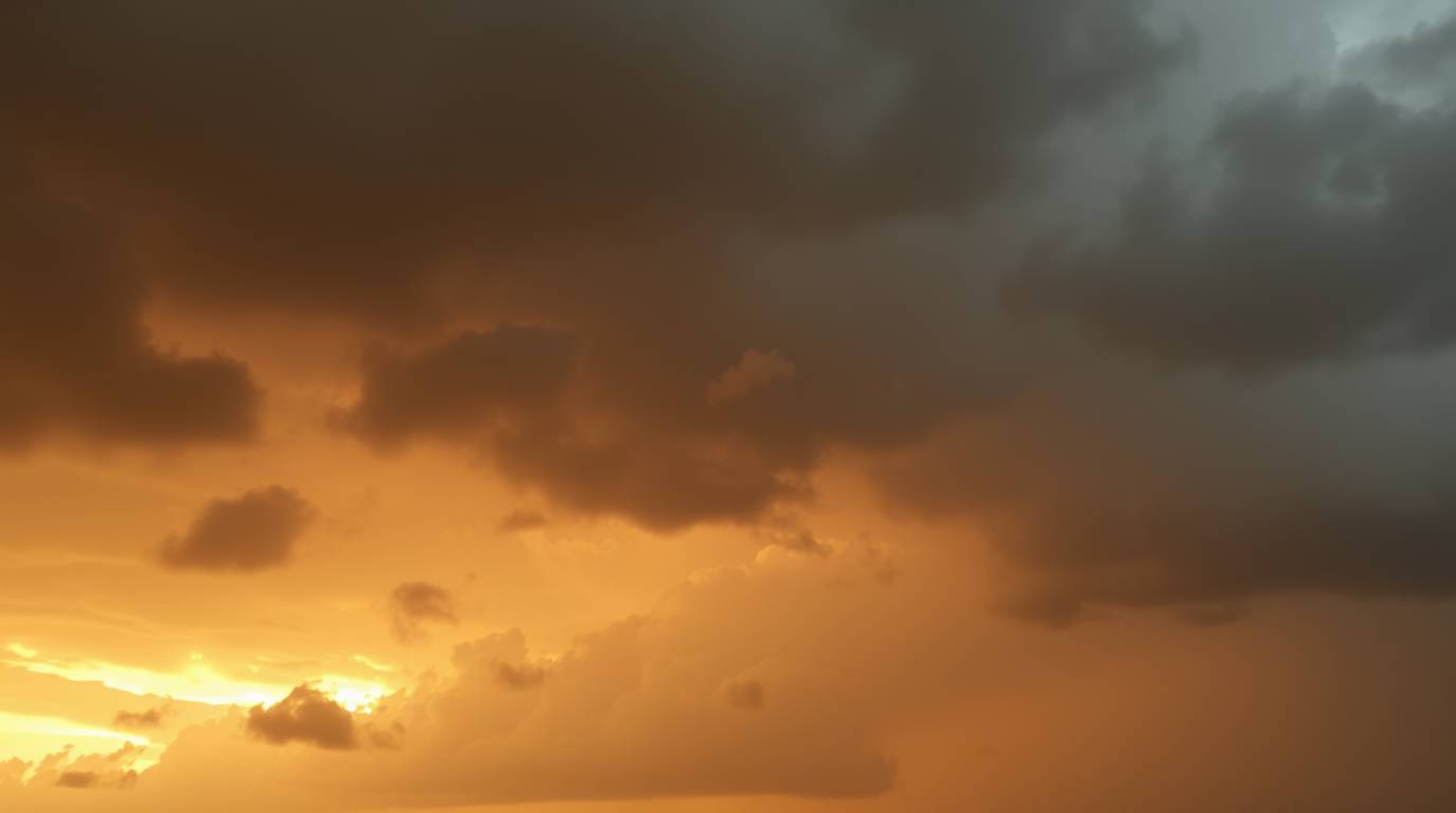 This artwork captures the dramatic beauty of volumetric lighting and natural earth tones.  Thunderstorm clouds are illuminate