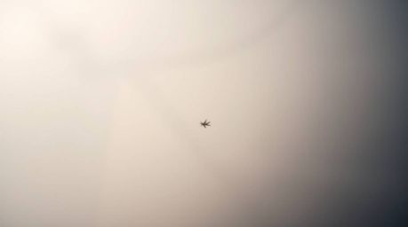 An extreme macro photograph captures a tiny subject shrouded in thick fog, creating a low-visibility scene.  The image utiliz