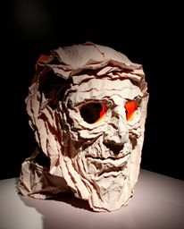 Explore a captivating layered papier-mâché sculpture exhibiting a vibrant glitch effect, dramatically highlighted by strong c