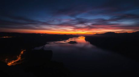 Experience the ethereal beauty of a river delta bathed in the soft glow of twilight. This image showcases a high-contrast, lo