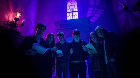 A group of teenagers unravels a chilling mystery within a dramatically lit haunted mansion.  The scene is steeped in deep ult