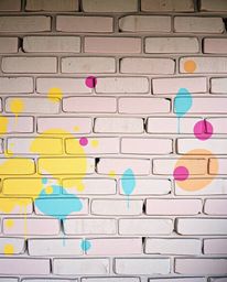 Discover stunning fine art photography featuring soft pastel graffiti-style splashes on a brick wall. This collection showcas