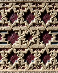 Explore a sophisticated and elegant image showcasing the beauty of Islamic geometric patterns meticulously carved in stone. T