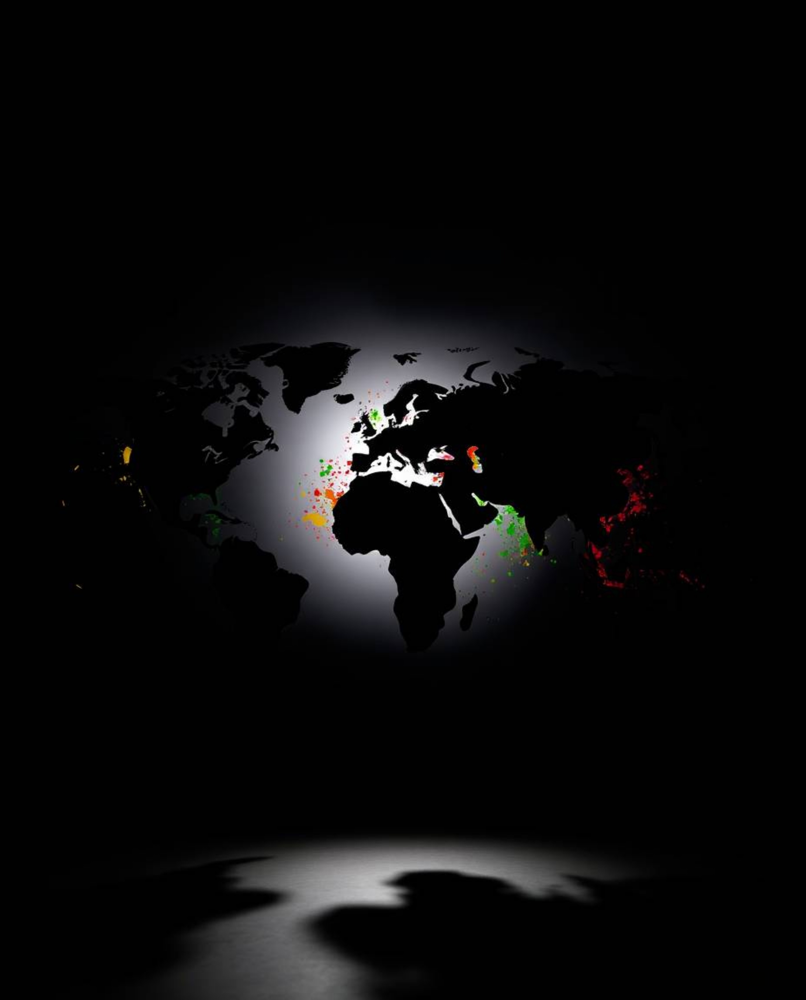 This striking image features a silhouetted world map beautifully formed from bright, colorful splashes, backlit by a strong l
