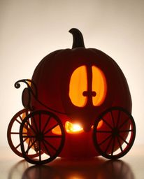 A captivating image of a magical pumpkin transforming into an elegant carriage, silhouetted against a radiant light source. R