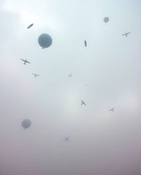 Experience a surreal storm scene featuring flying objects rendered in soft pastel colors. The low visibility and thick fog cr