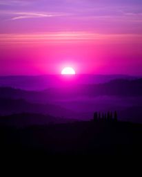 This artwork depicts a massive, heroic scene of a Tuscan sunset over misty, rolling hills, characterized by its deep ultravio